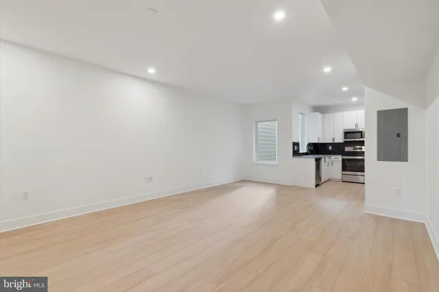 a view of kitchen with refrigerator and window
