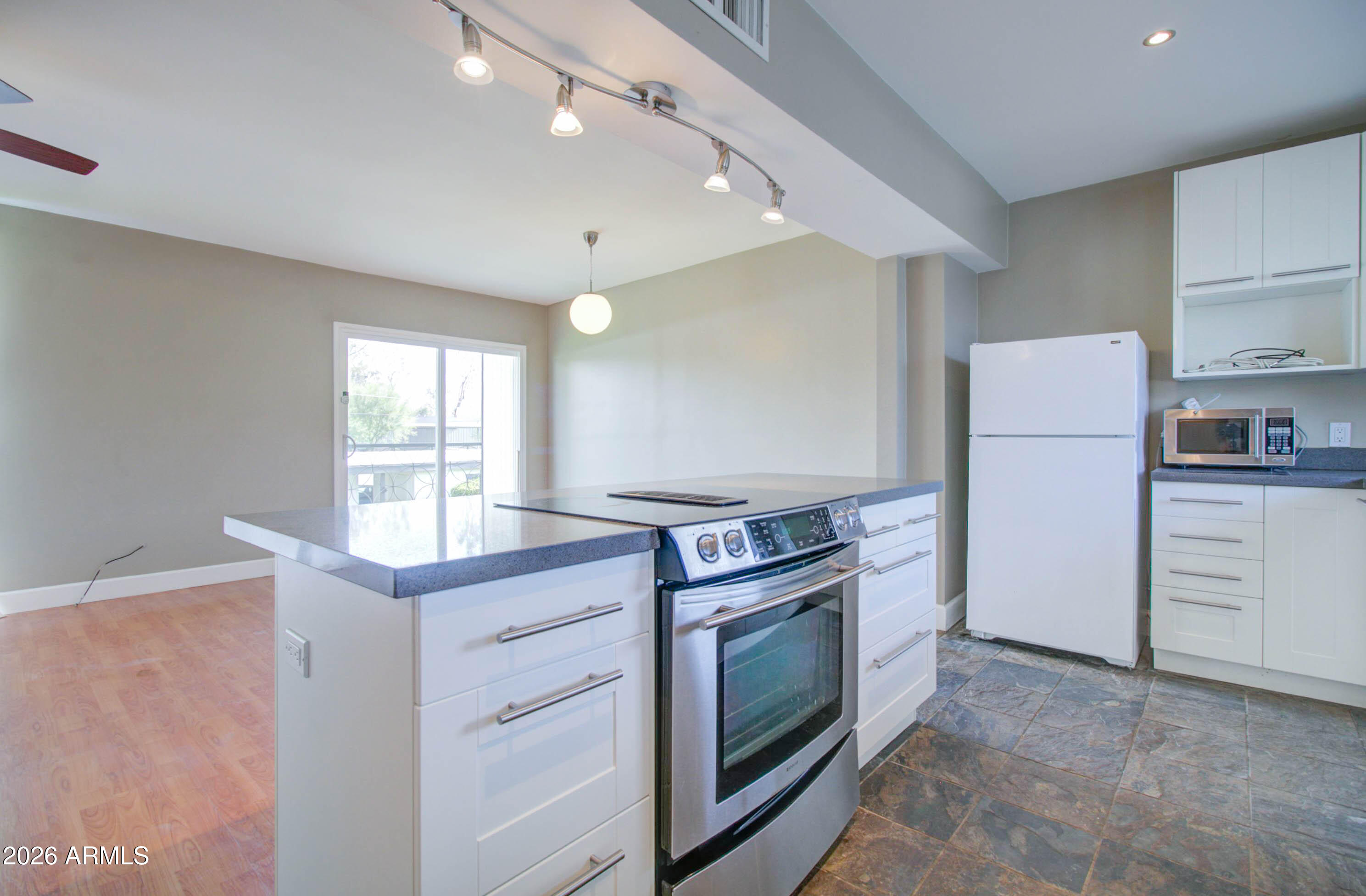 3242 East Camelback Road, Unit 207 Phoenix, AZ 85018 - Photo 9 of 25 Kitchen w/ White Shaker Cabinetry