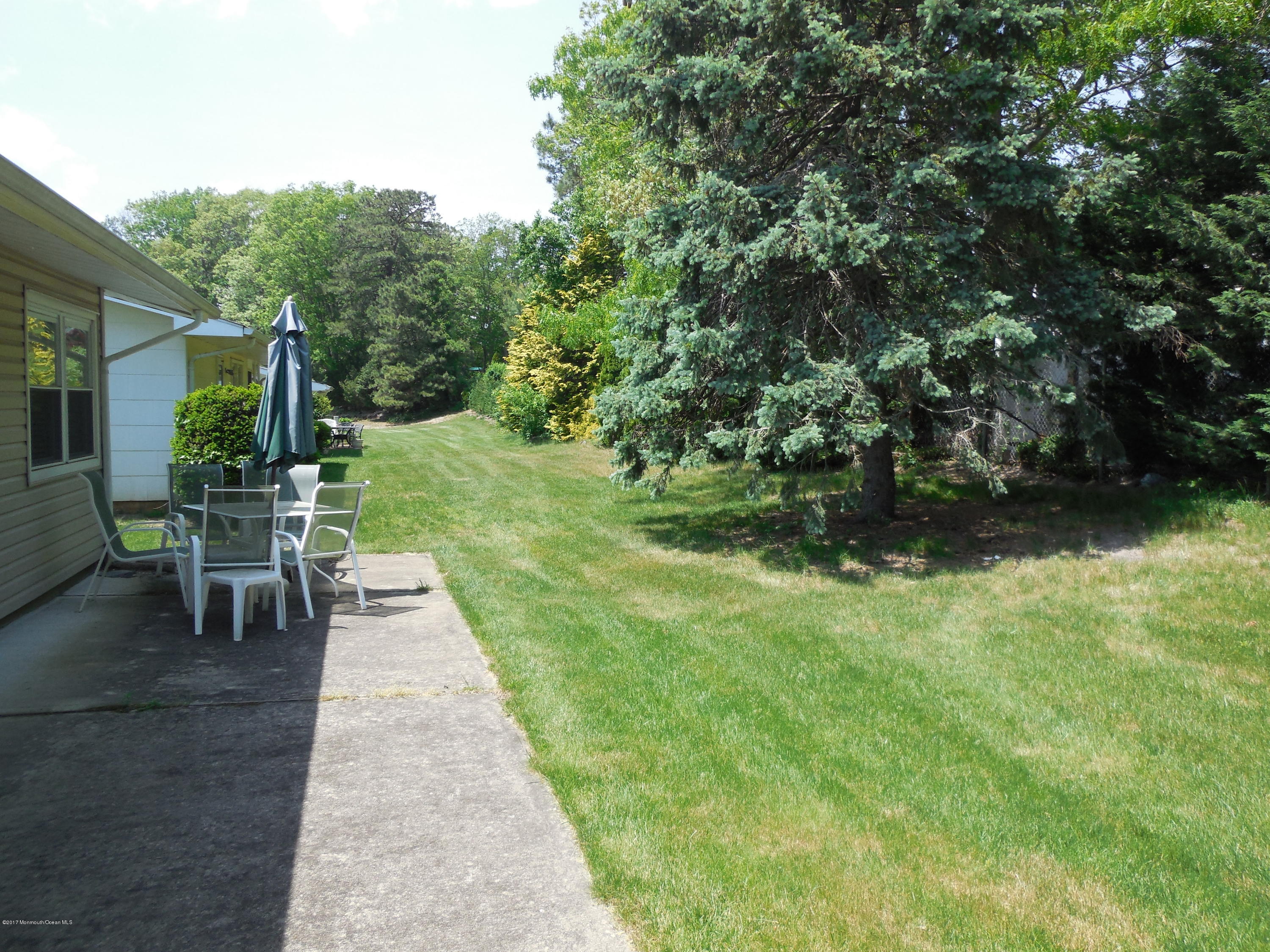 26 Phillips Road Brick, NJ 08724 - Photo 14 of 16 a view of a table and chairs in the garden