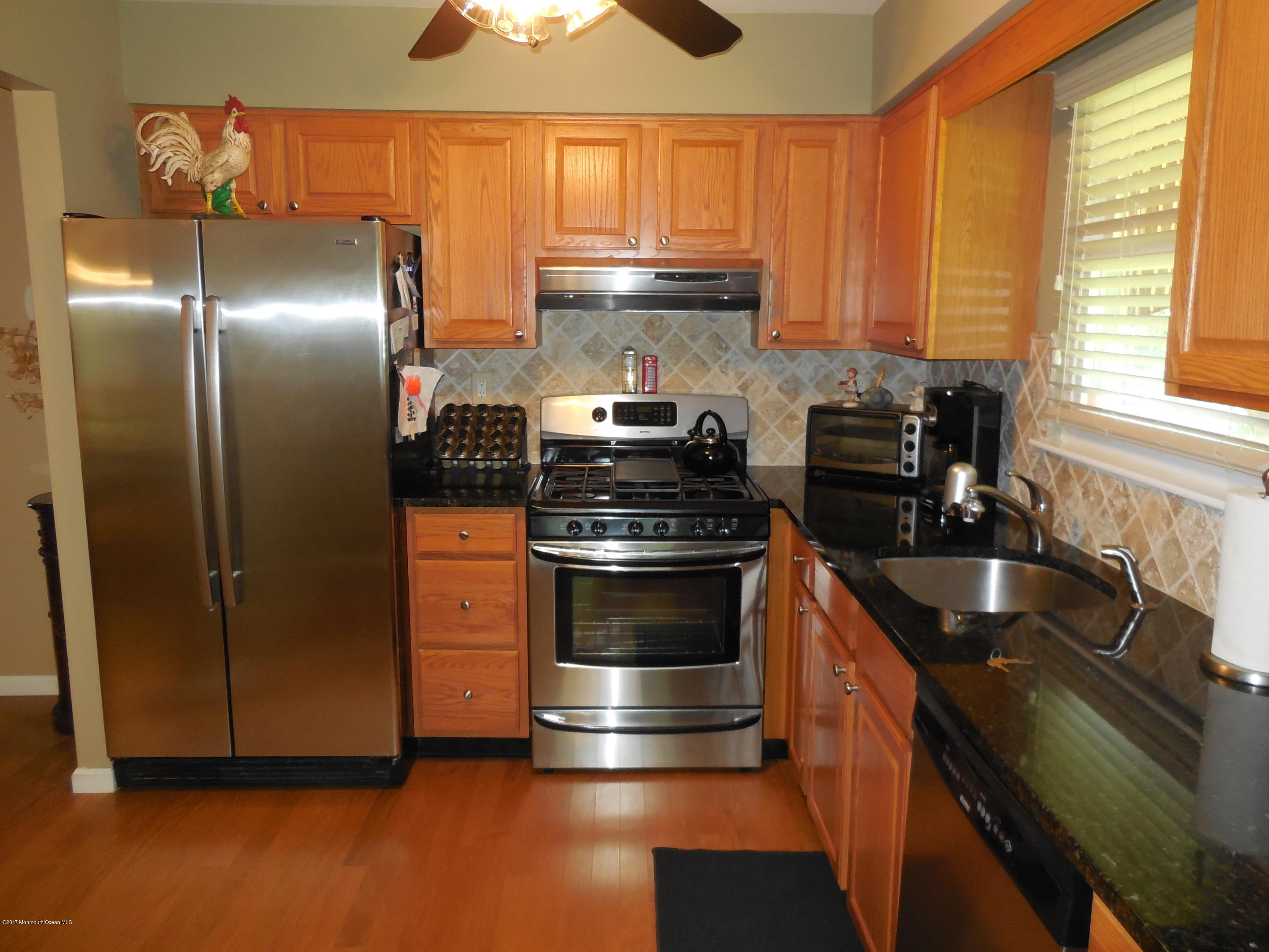 26 Phillips Road Brick, NJ 08724 - Photo 8 of 16 a kitchen with granite countertop a stove and a sink