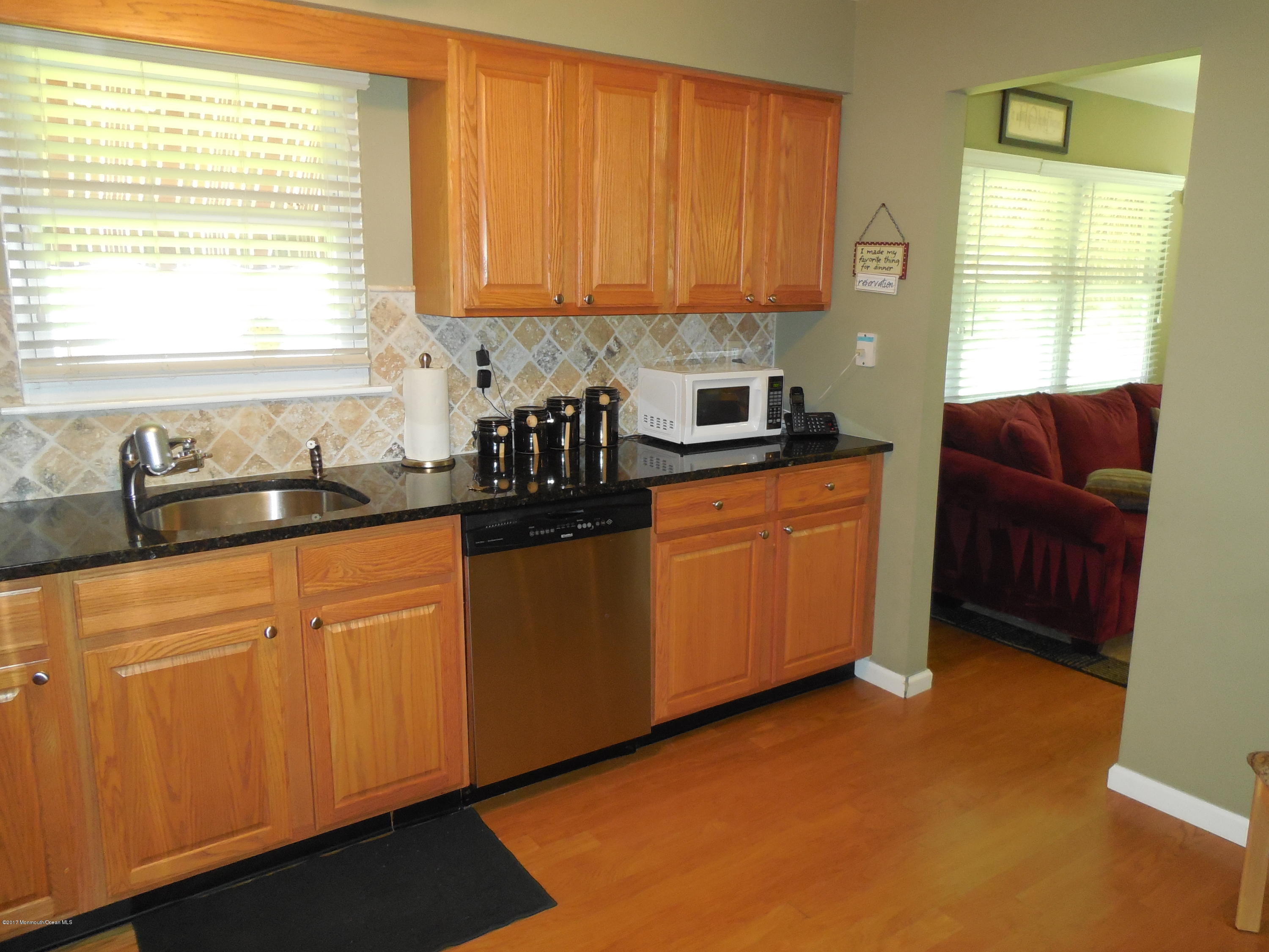 26 Phillips Road Brick, NJ 08724 - Photo 9 of 16 a kitchen with stainless steel appliances granite countertop a sink a stove cabinets and a window