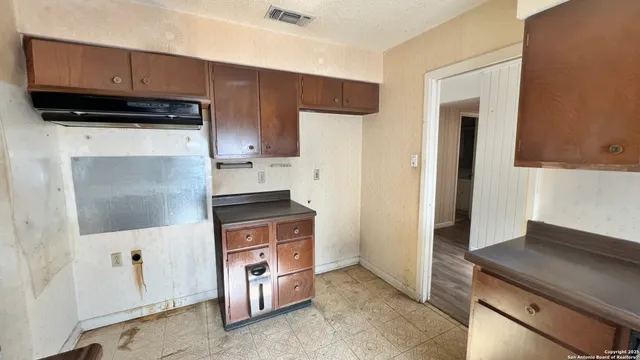 a kitchen with stainless steel appliances granite countertop a stove and a refrigerator