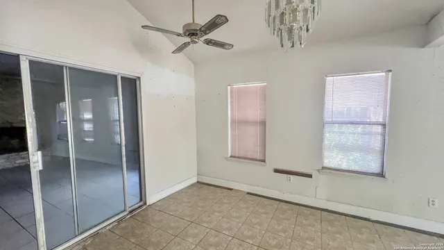 wooden floor with a chandelier in a room