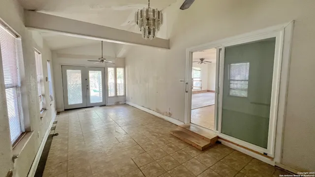 a view of an empty room with window and fire place