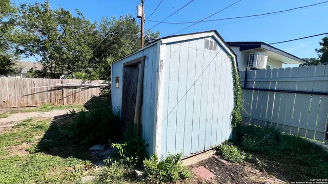 a view of a small house with potted plants