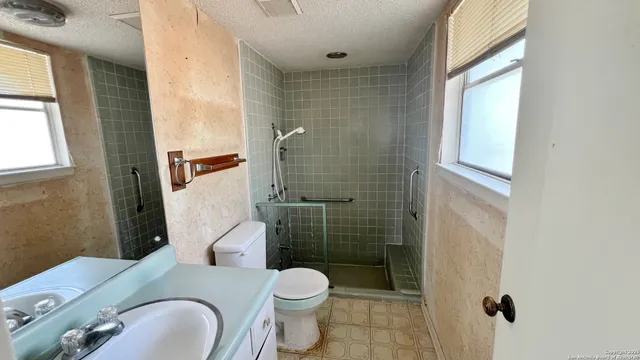 a white toilet sitting next to a bathroom sink