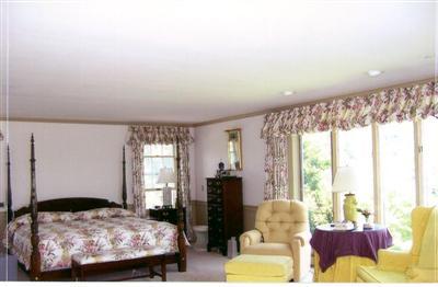 265 Bay Road Harwich, MA 02645 - Photo 6 of 11 a bedroom with a bed and glass window