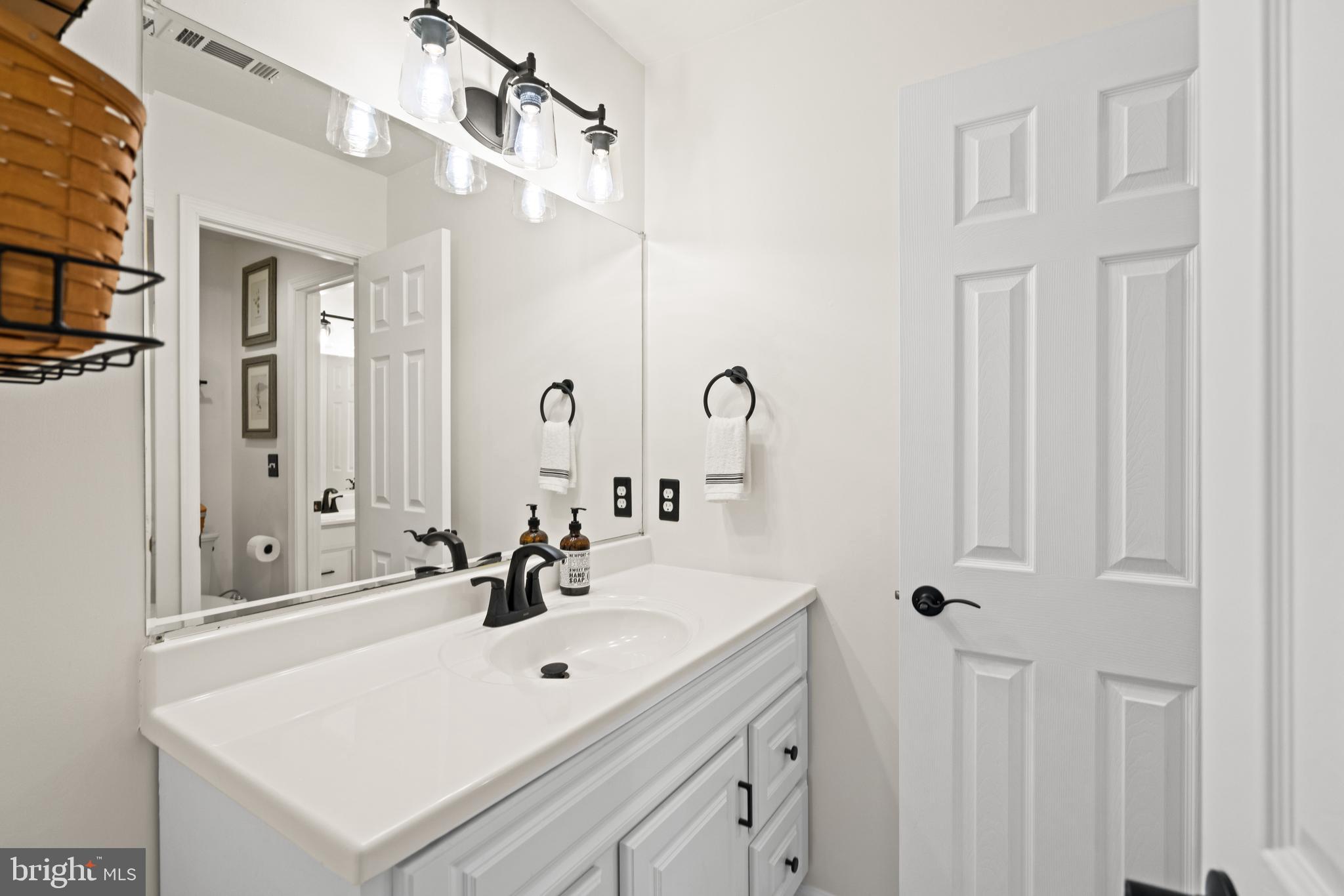 10448 Wheatley School Road Marshall, VA 20115 - Photo 26 of 43 a bathroom with a sink and a mirror