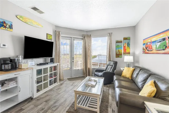 a living room with furniture and a wall painting