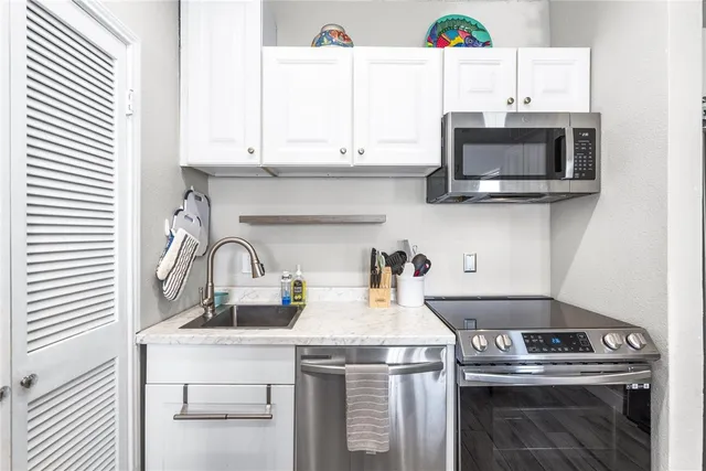 a bathroom with a sink and mirror with bathtub
