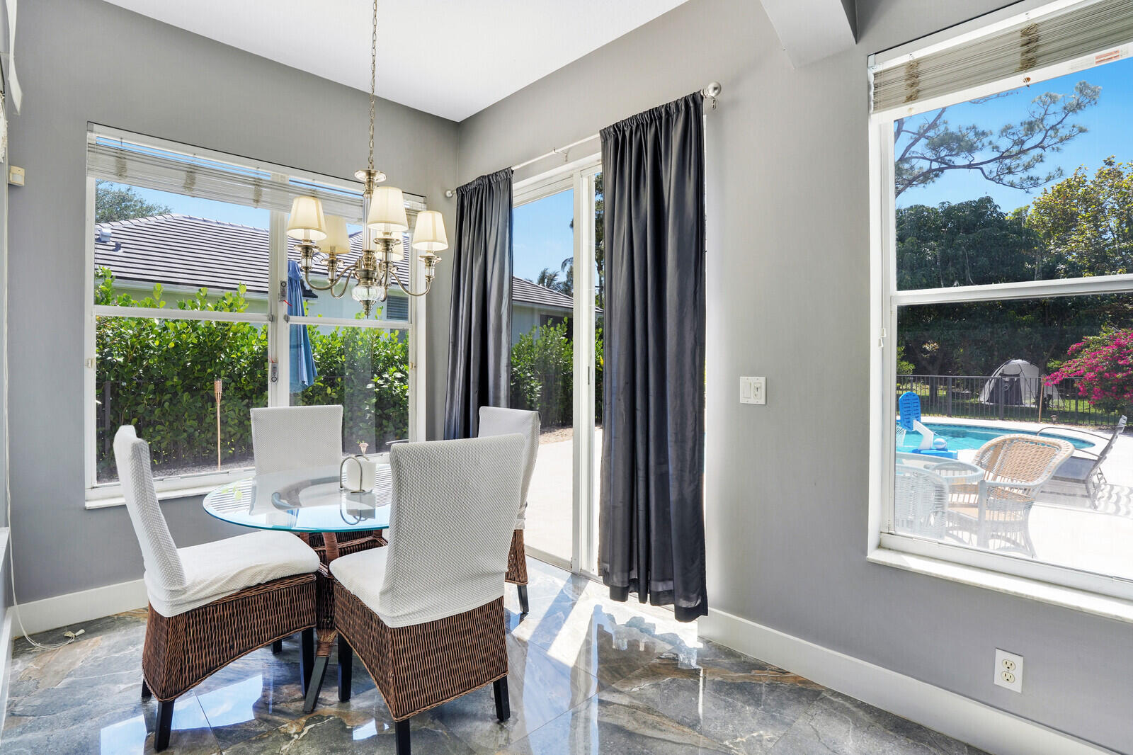 403 Mangrove Point Jupiter, FL 33458 - Photo 18 of 51 a dining room with furniture a rug and a floor to ceiling window