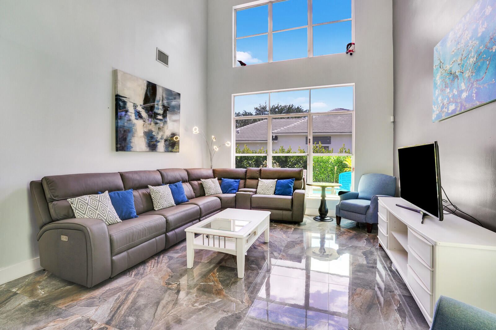 403 Mangrove Point Jupiter, FL 33458 - Photo 7 of 51 a living room with furniture a flat screen tv and a window