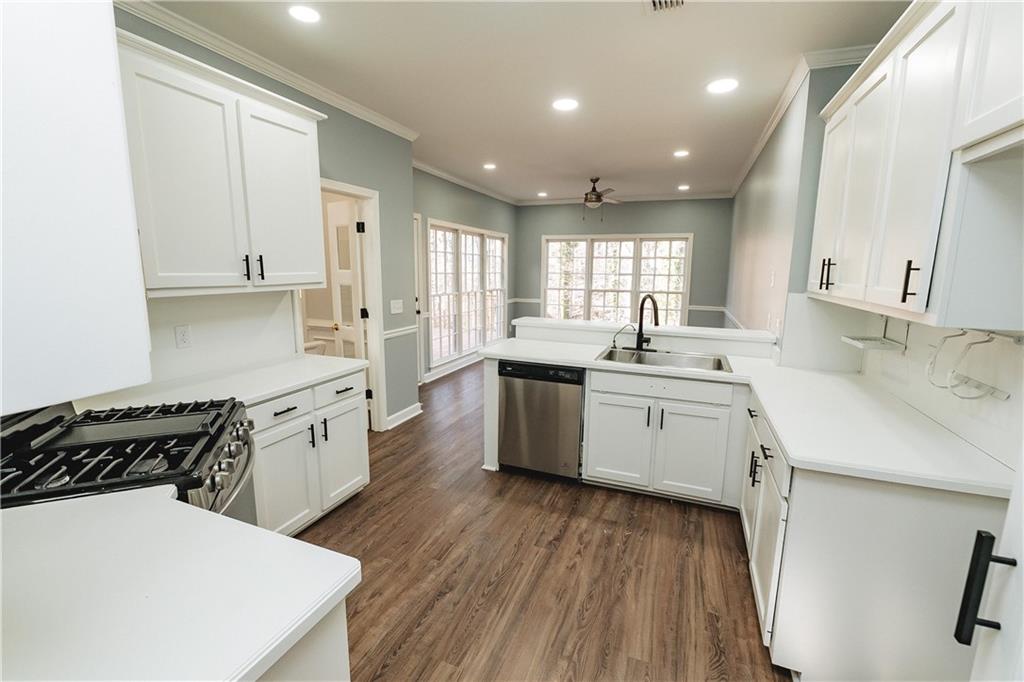 525 Rams Way Tucker, GA 30084 - Photo 21 of 41 a kitchen with a sink a stove a refrigerator and white cabinets