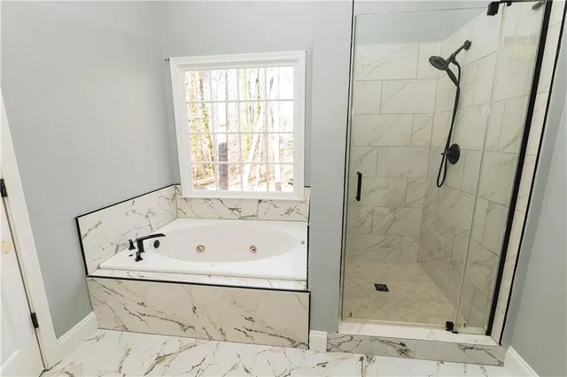 a bathroom with a bathtub and shower