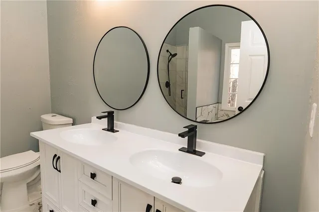 a bathroom with a sink a mirror and a toilet