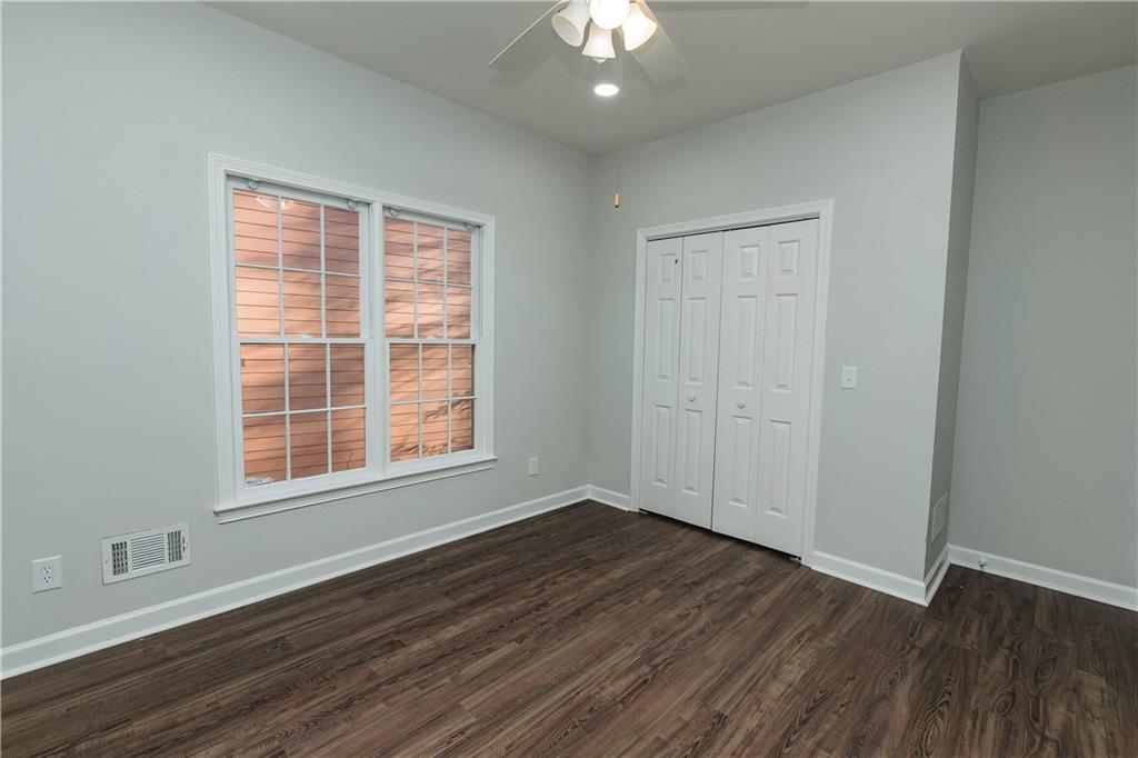 525 Rams Way Tucker, GA 30084 - Photo 37 of 41 an empty room with wooden floor and windows