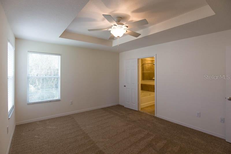 15810 Fishhawk View Drive Lithia, FL 33547 - Photo 11 of 34 an empty room with windows and closet