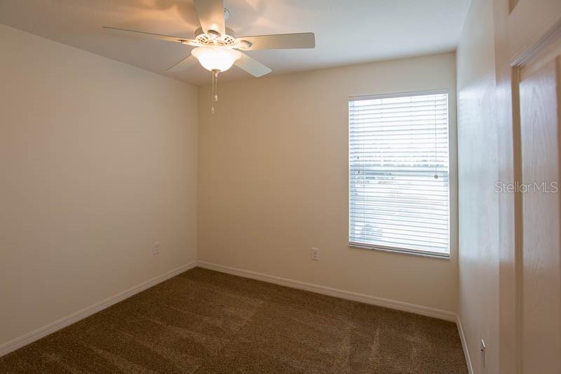15810 Fishhawk View Drive Lithia, FL 33547 - Photo 17 of 34 an empty room with a window and a fan