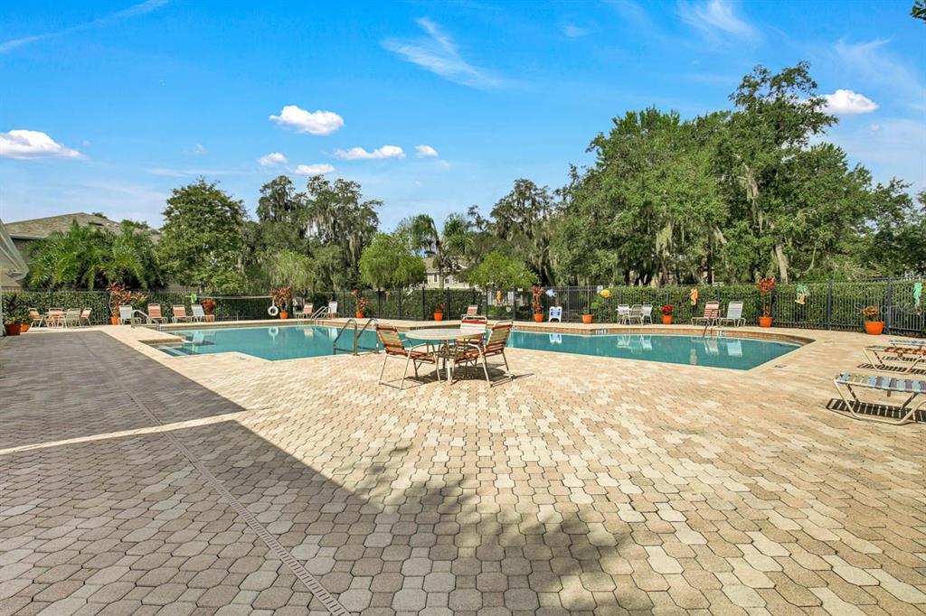 15810 Fishhawk View Drive Lithia, FL 33547 - Photo 27 of 34 a white bench sitting in the middle of a park