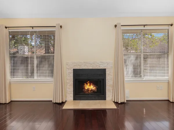 a living room with a fireplace and a window