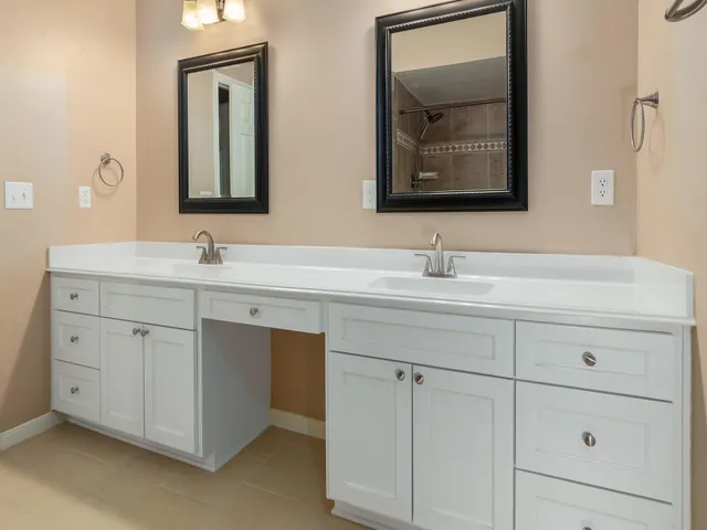 a bathroom with a double vanity sink and mirror