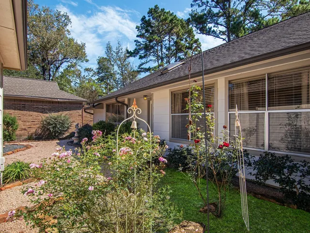 a front view of a house with a yard and potted plants