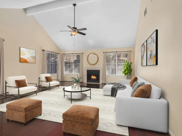 a living room with furniture a fireplace and a window