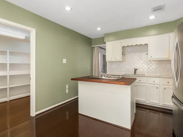 a kitchen with stainless steel appliances granite countertop white cabinets and a granite counter tops