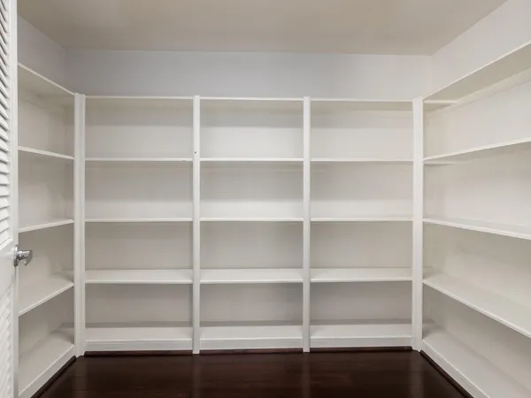 a view of walk in closet with empty racks