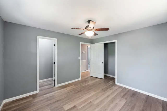 a view of an empty room with wooden floor