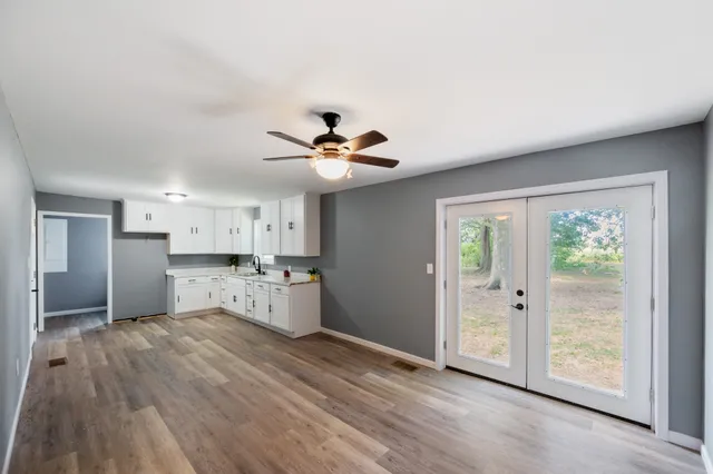 a living room with stainless steel appliances kitchen island granite countertop furniture and a view of kitchen