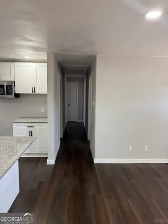 a view of a kitchen with a sink and dishwasher wooden floor