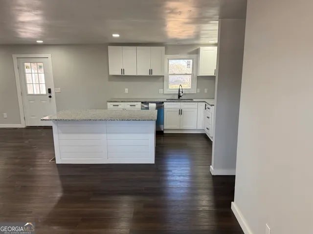 a kitchen with stainless steel appliances granite countertop a sink stove and cabinets