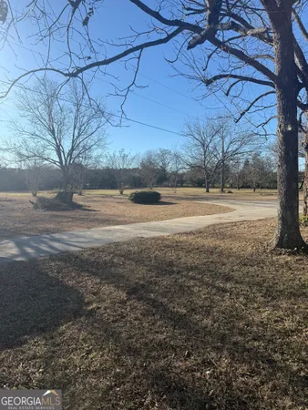 a view of a yard with wooden fence