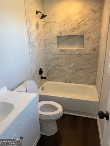 a bathroom with a toilet and a bathtub
