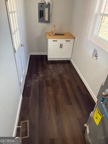 a room with wooden floor and white walls