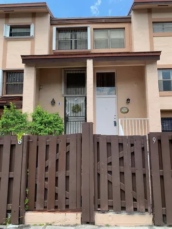 a front view of a house with wooden fence