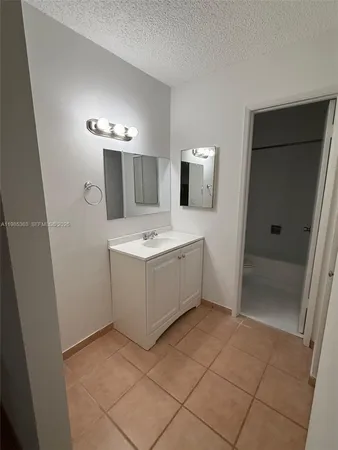 a bathroom with a sink a mirror and a shower