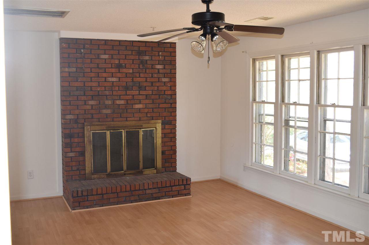 1513 Creech Road Garner, NC 27529 - Photo 2 of 10 a living room with furniture a window and a fireplace