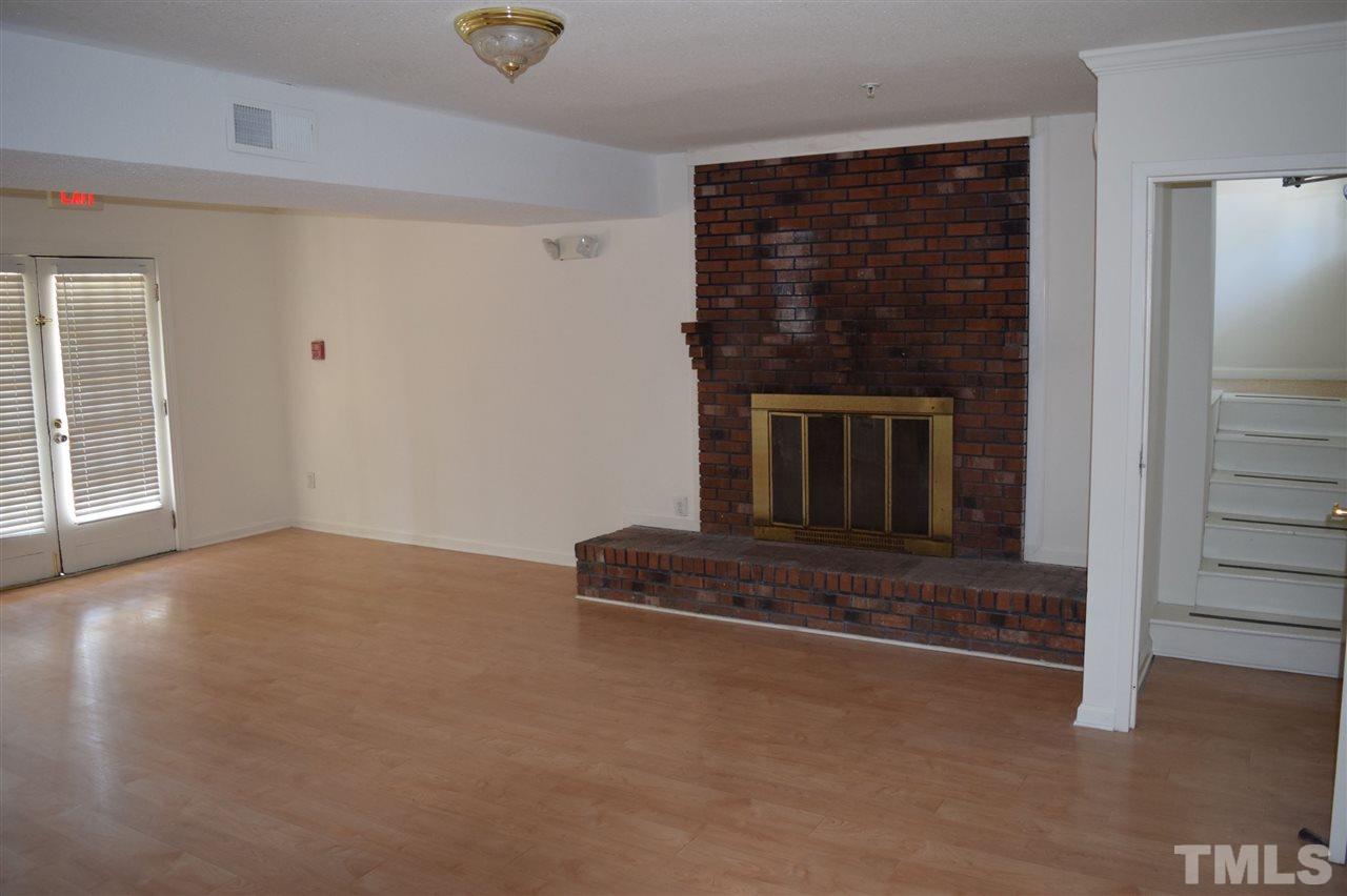 1513 Creech Road Garner, NC 27529 - Photo 6 of 10 an empty room with fireplace