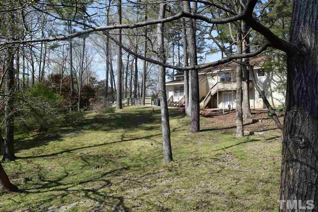 1513 Creech Road Garner, NC 27529 - Photo 8 of 10 a backyard of a house with lots of green space