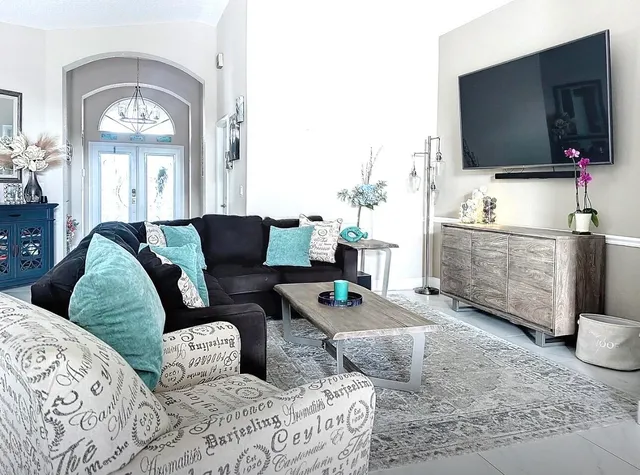 a living room with furniture and a flat screen tv