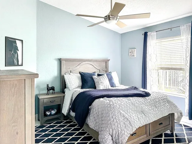 a bedroom with a bed and a window