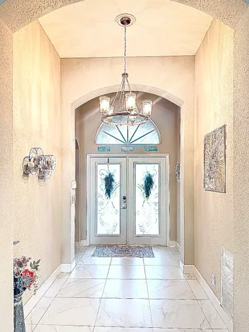 a front view of a house with a chandelier and glass door