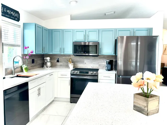 a kitchen with a sink cabinets and stainless steel appliances