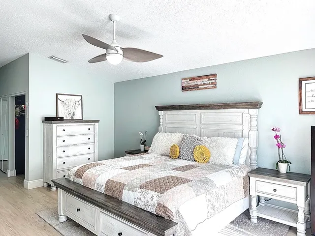 a bedroom with a bed and a chandelier
