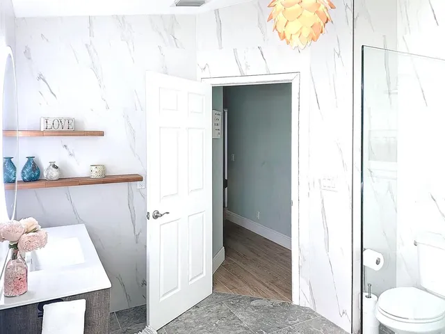 a bathroom with a sink toilet and shower