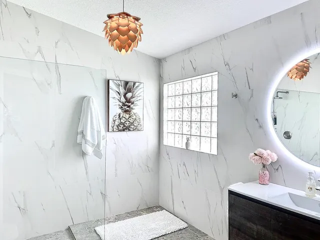 a bathroom with a sink a mirror and a shower