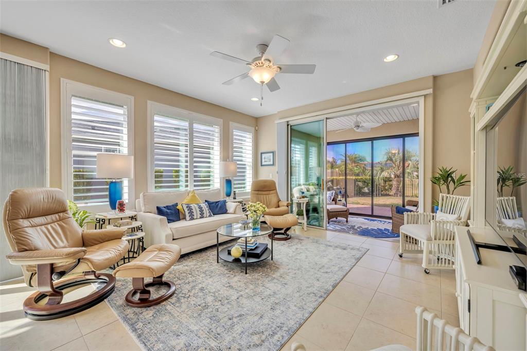 115 Bayou Bend Road Groveland, FL 34736 - Photo 17 of 47 a living room with furniture and floor to ceiling windows