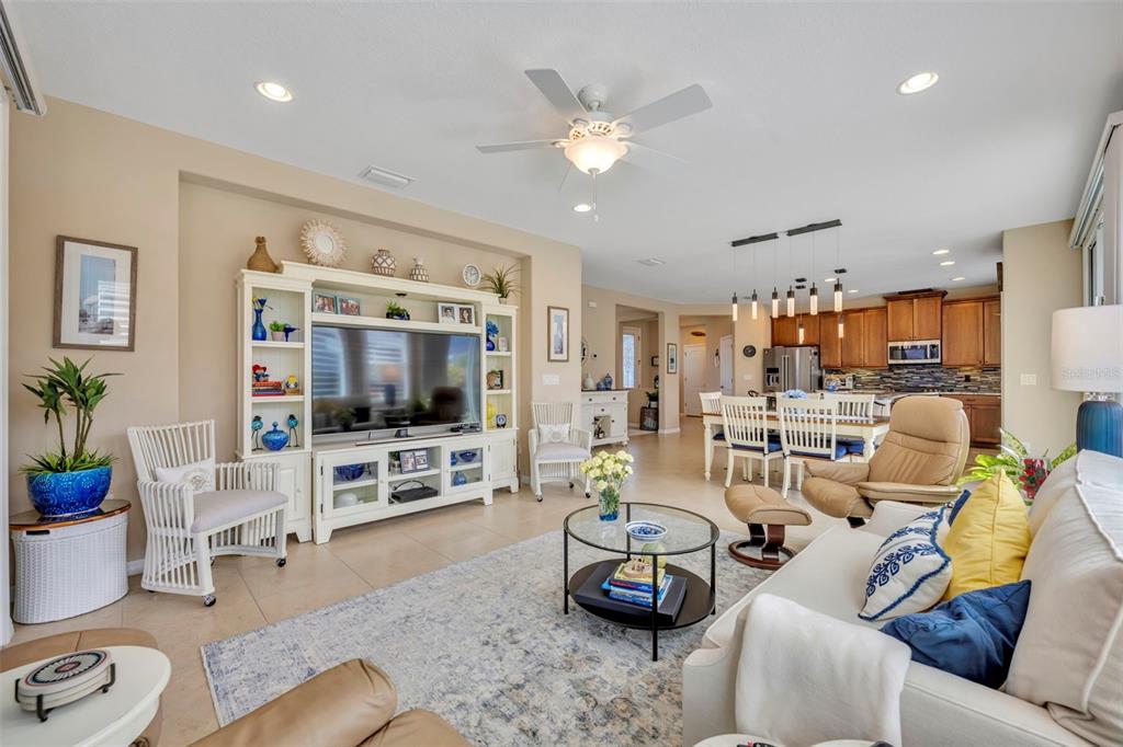 115 Bayou Bend Road Groveland, FL 34736 - Photo 19 of 47 a living room with furniture and a flat screen tv with wooden floor